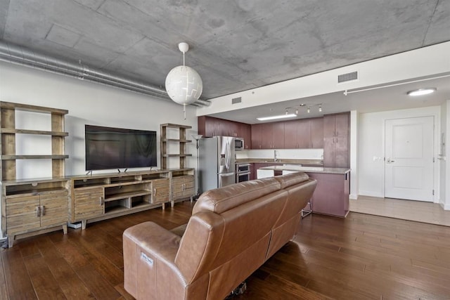 living room featuring dark hardwood / wood-style flooring and sink