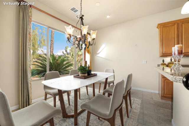 tiled dining space with an inviting chandelier