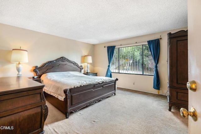 bedroom with light colored carpet and a textured ceiling