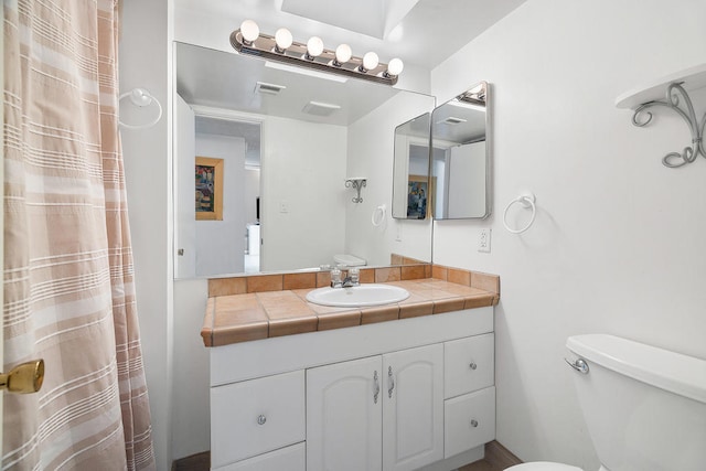 bathroom with toilet and vanity