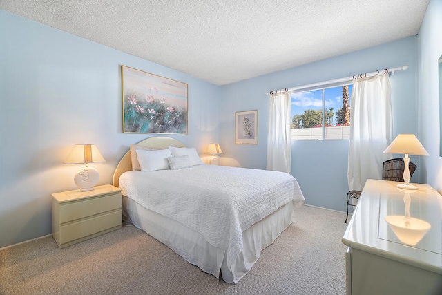 bedroom with a textured ceiling and light carpet