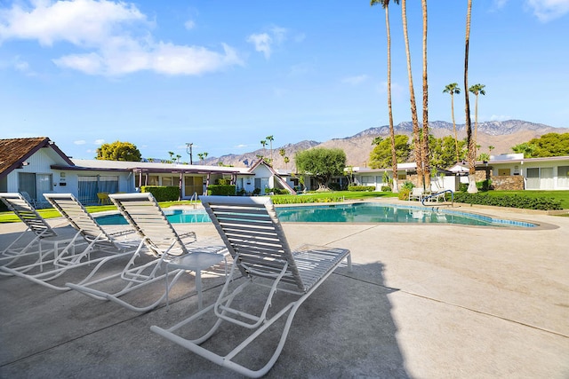 view of pool with a mountain view and a patio area