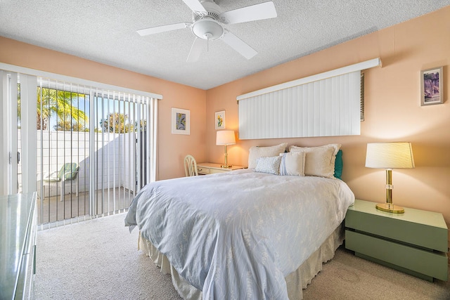 bedroom featuring access to outside, light colored carpet, ceiling fan, and a textured ceiling