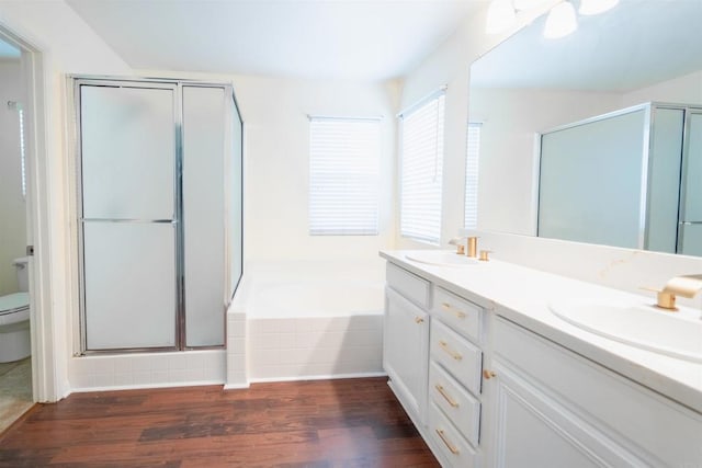 full bathroom with toilet, ceiling fan, separate shower and tub, wood-type flooring, and vanity