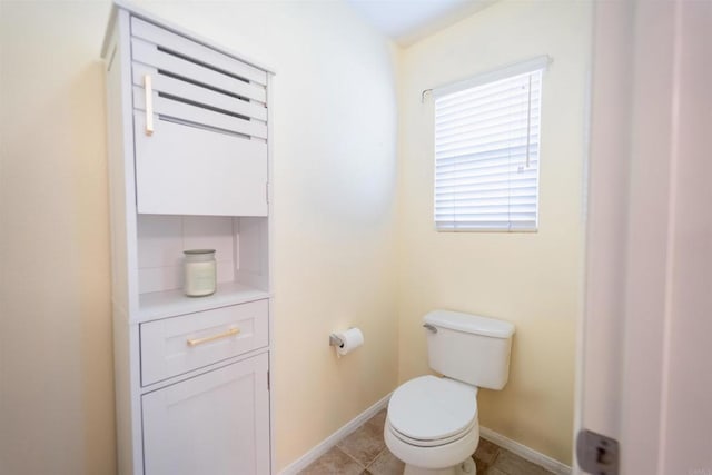 bathroom featuring toilet and tile patterned flooring