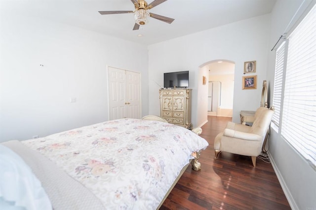 bedroom featuring ceiling fan, dark wood-type flooring, and a closet