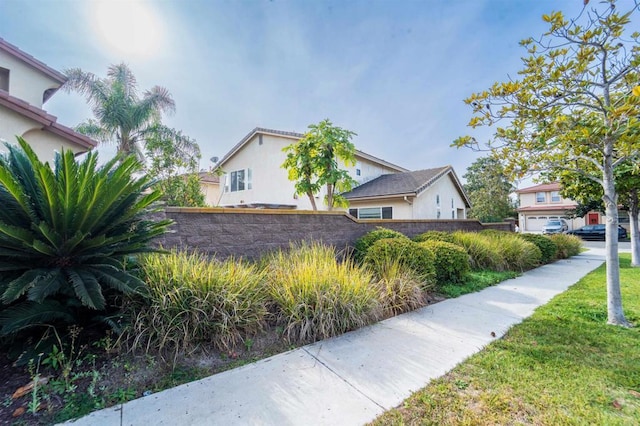 view of property exterior with a lawn