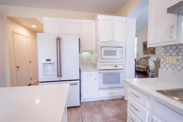 kitchen with white cabinetry, white appliances, exhaust hood, and tasteful backsplash