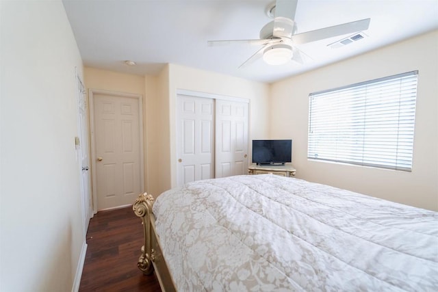 bedroom with ceiling fan, a closet, and dark hardwood / wood-style flooring