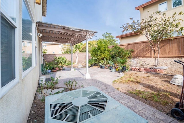 view of patio with central AC and a pergola