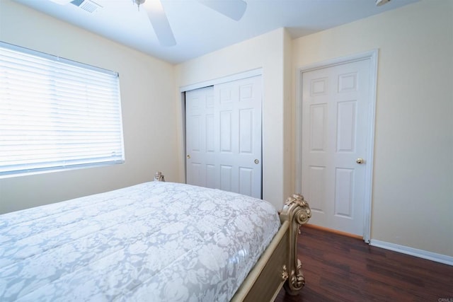 bedroom with ceiling fan, a closet, and dark hardwood / wood-style flooring