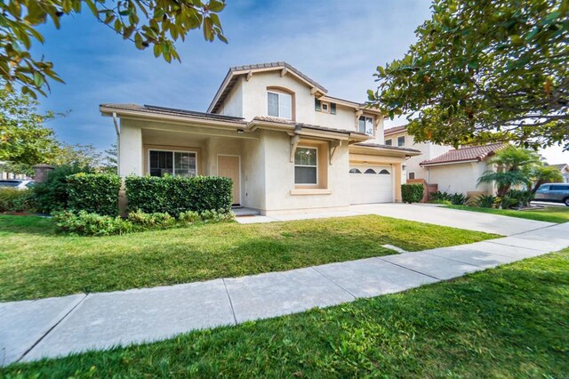 view of front of home with a front yard and a garage