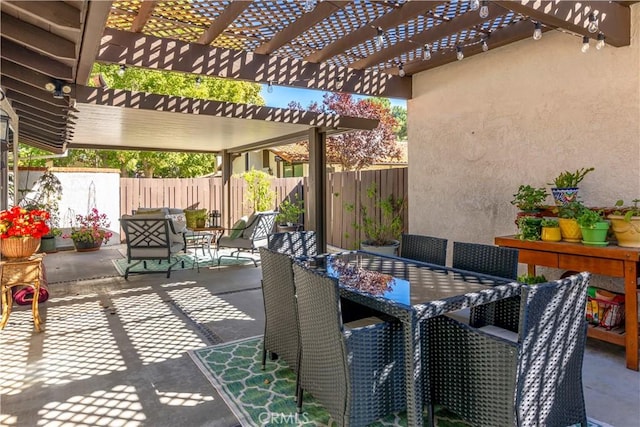 view of patio featuring outdoor dining space, a fenced backyard, and a pergola