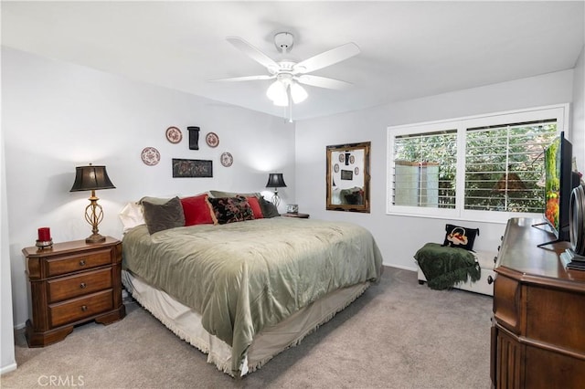 bedroom with ceiling fan and light carpet