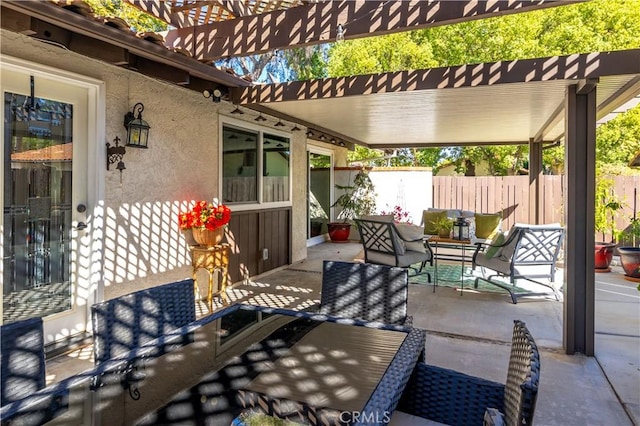 view of patio with fence, an outdoor hangout area, and a pergola