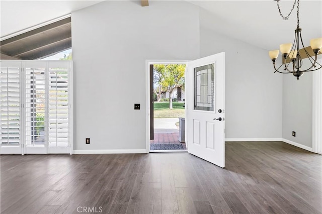 entryway with baseboards, vaulted ceiling with beams, an inviting chandelier, and wood finished floors