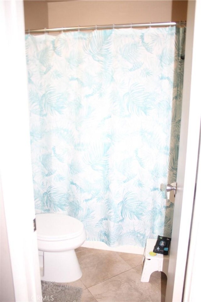 bathroom featuring tile patterned floors and toilet