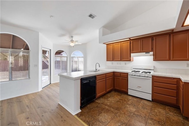 kitchen featuring kitchen peninsula, ceiling fan, dishwasher, white range, and sink