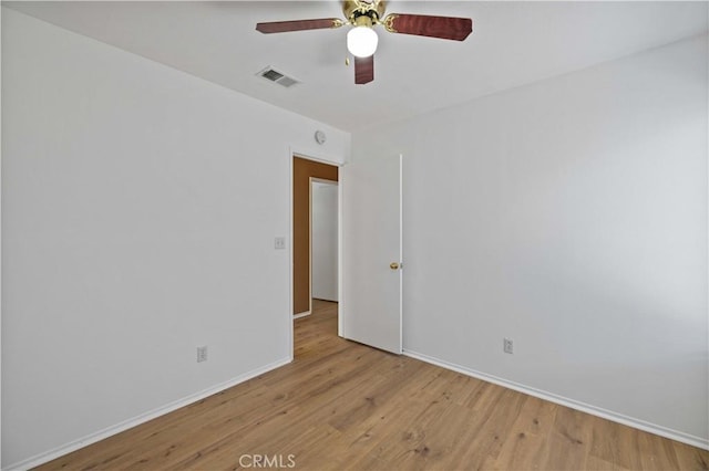 spare room with ceiling fan and light wood-type flooring