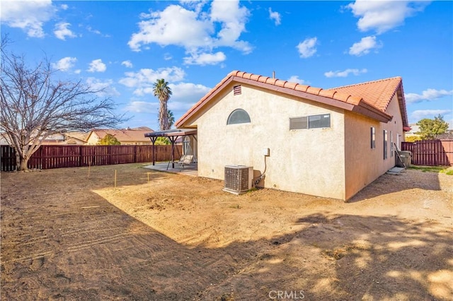 back of house featuring central AC and a patio