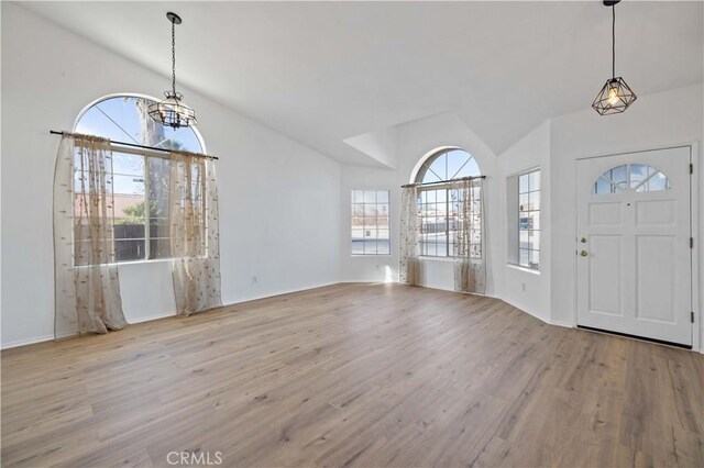 entrance foyer with light wood-type flooring and lofted ceiling