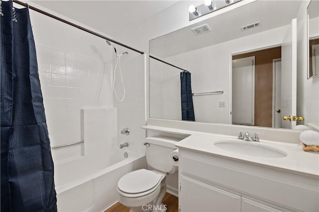 full bathroom with shower / bath combo with shower curtain, hardwood / wood-style floors, toilet, and vanity