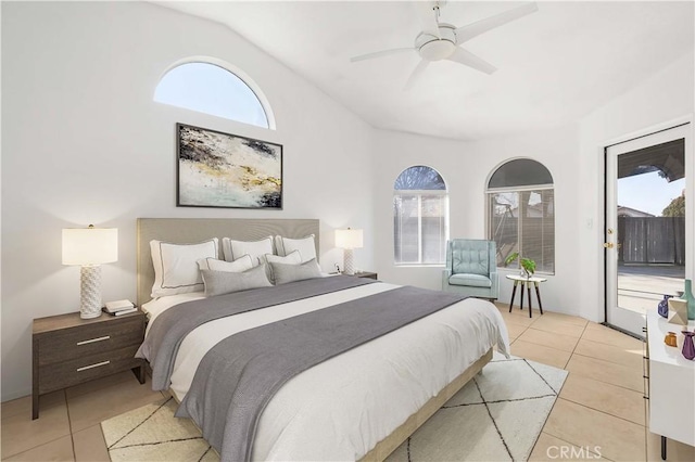 tiled bedroom with ceiling fan, access to exterior, and lofted ceiling