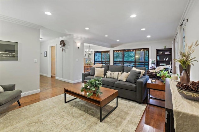 living room featuring ornamental molding, light hardwood / wood-style flooring, and a notable chandelier