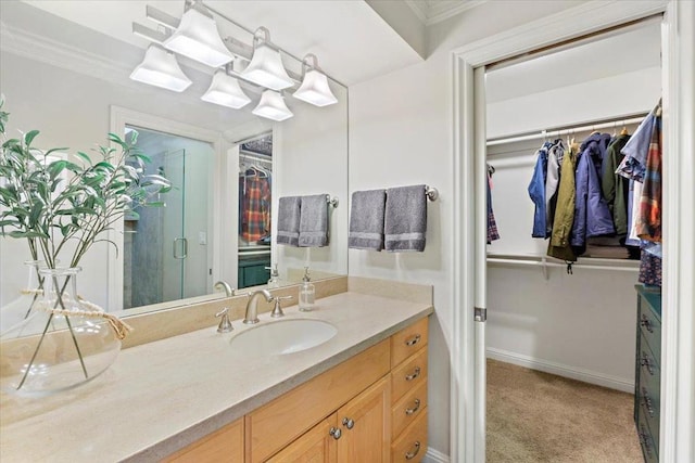 bathroom with an inviting chandelier, crown molding, and vanity