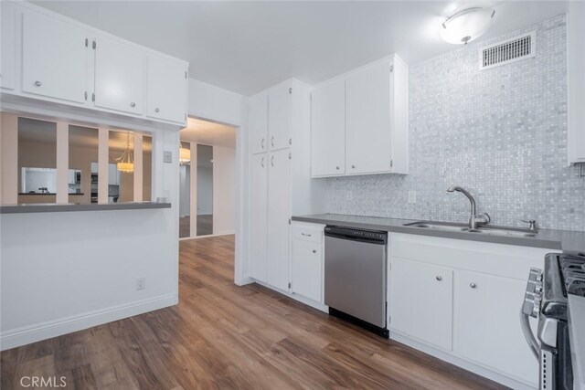 kitchen featuring hardwood / wood-style flooring, range, stainless steel dishwasher, white cabinets, and sink