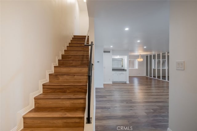 staircase with hardwood / wood-style floors