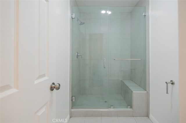 bathroom featuring a shower with shower door and tile patterned floors