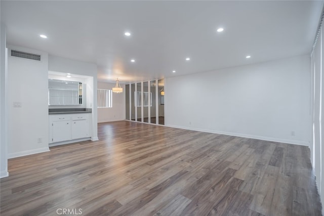 unfurnished living room featuring hardwood / wood-style flooring