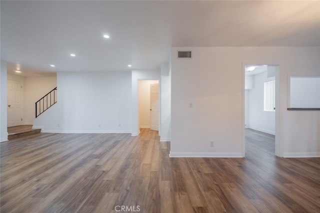 unfurnished living room with dark wood-type flooring