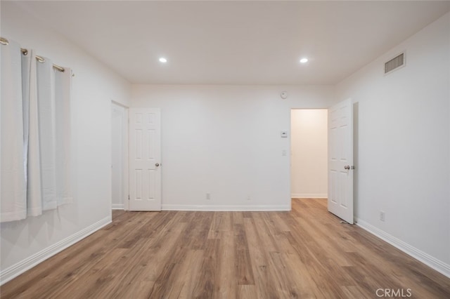 spare room with light hardwood / wood-style flooring