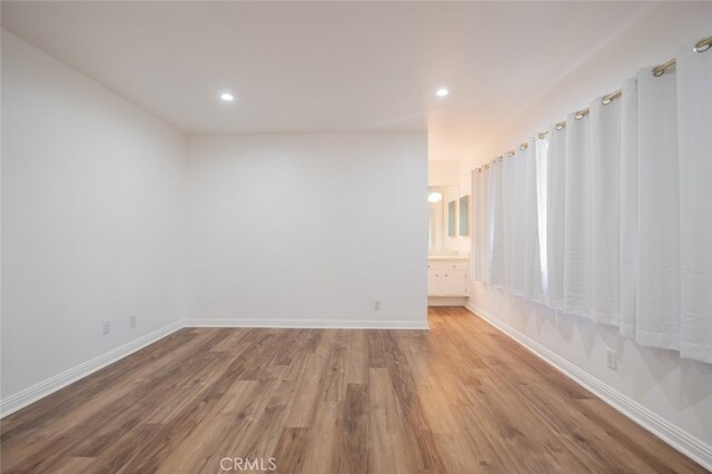 spare room with light hardwood / wood-style floors