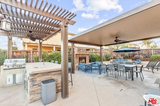 view of patio / terrace with a grill, sink, ceiling fan, area for grilling, and a pergola