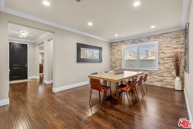 dining space featuring dark hardwood / wood-style flooring and crown molding