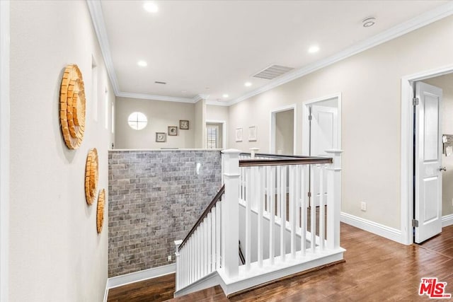 hall with dark wood-type flooring and crown molding