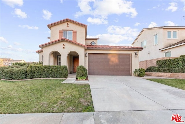 mediterranean / spanish-style home featuring a garage and a front yard