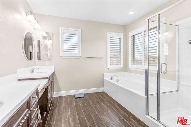 bathroom with separate shower and tub and vanity