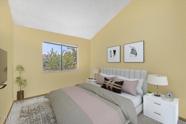 carpeted bedroom featuring a textured ceiling and vaulted ceiling