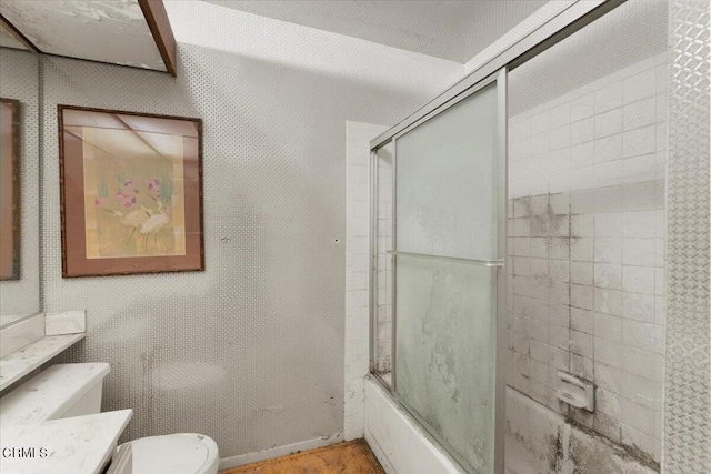 full bathroom featuring shower / bath combination with glass door, vanity, and toilet