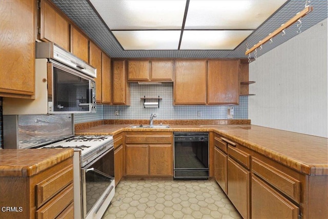 kitchen featuring dishwasher, kitchen peninsula, decorative backsplash, sink, and white gas range