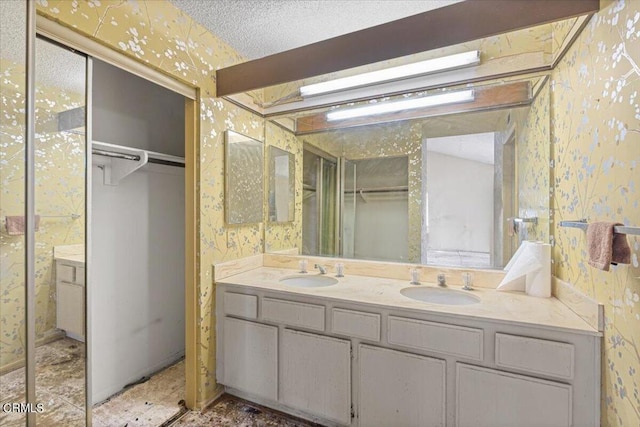 bathroom with a textured ceiling and vanity