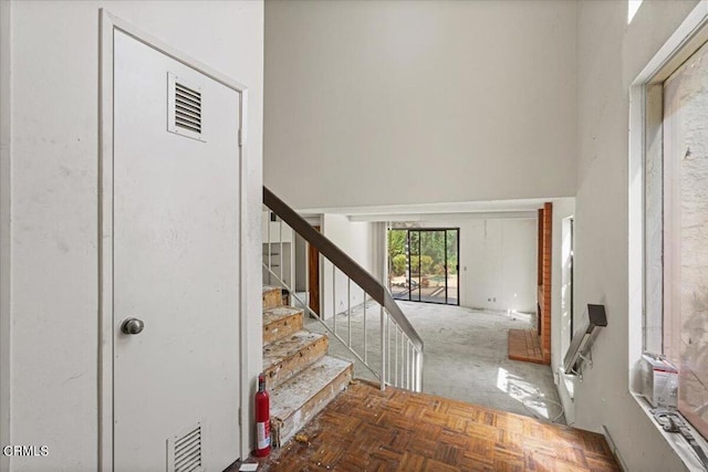 foyer entrance featuring dark parquet floors