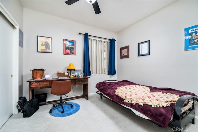 carpeted bedroom featuring ceiling fan and a closet