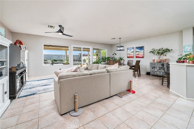 living room featuring light tile patterned floors and ceiling fan