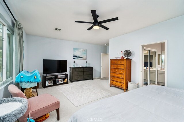 carpeted bedroom featuring connected bathroom and ceiling fan