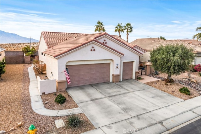 view of front of property featuring a mountain view and a garage